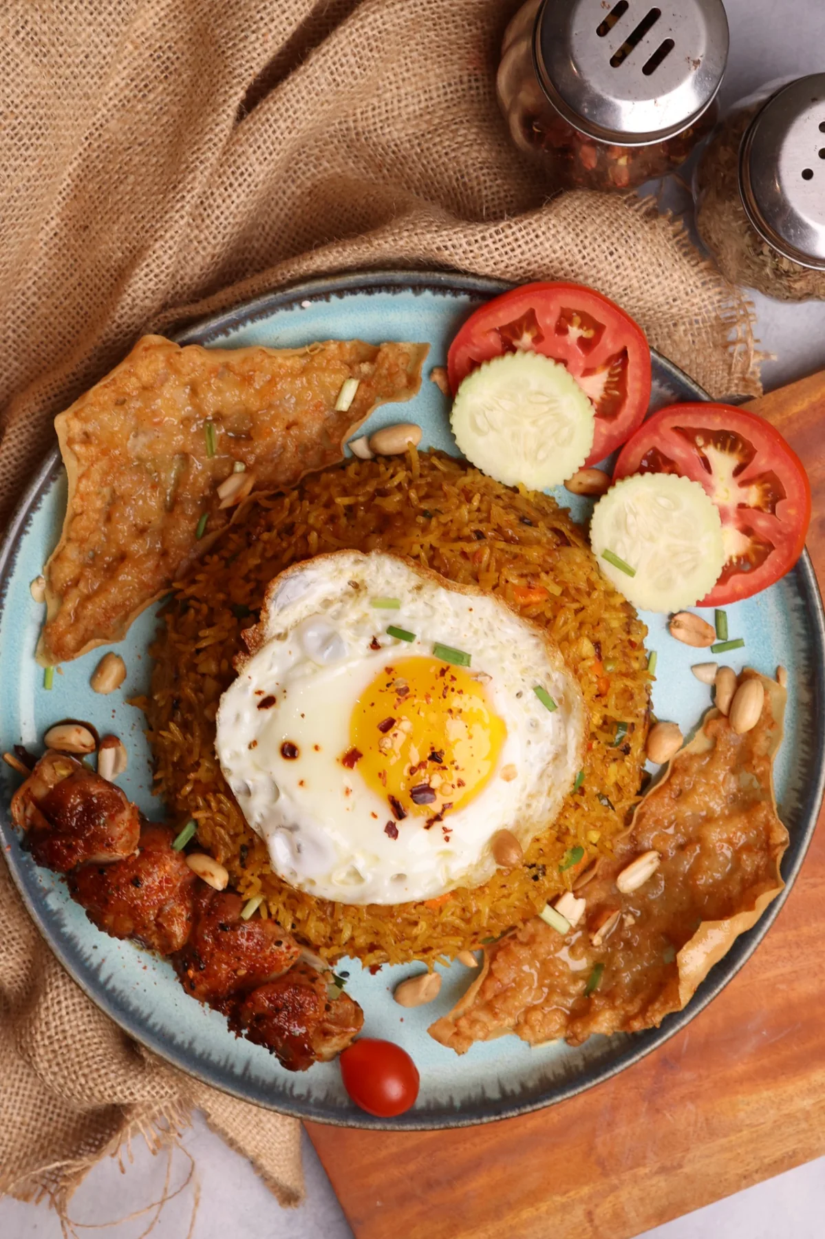Nasi Goreng with fried egg, chicken skewers and crisp wontons